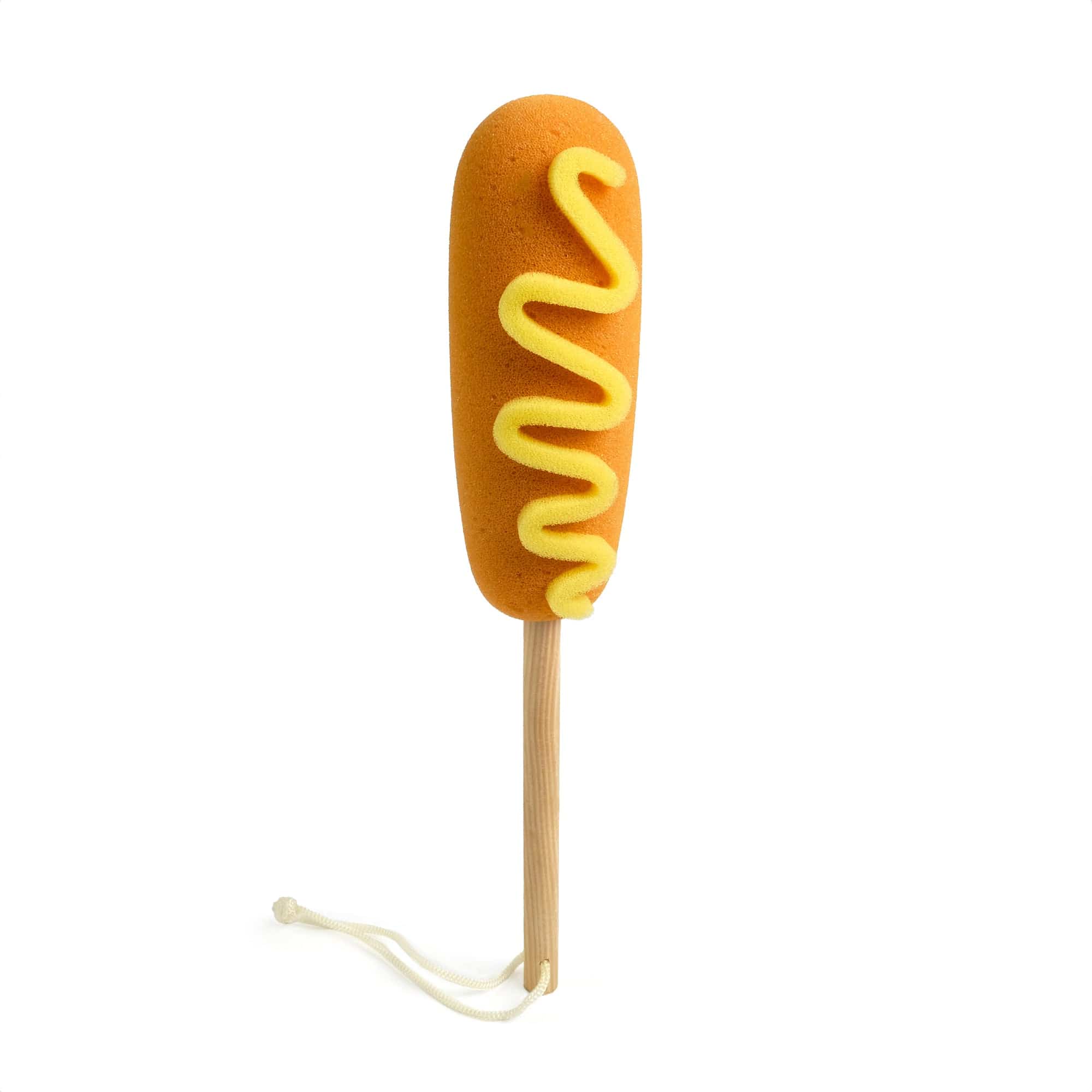 A bottle brush that looks like a corn dog with mustard.