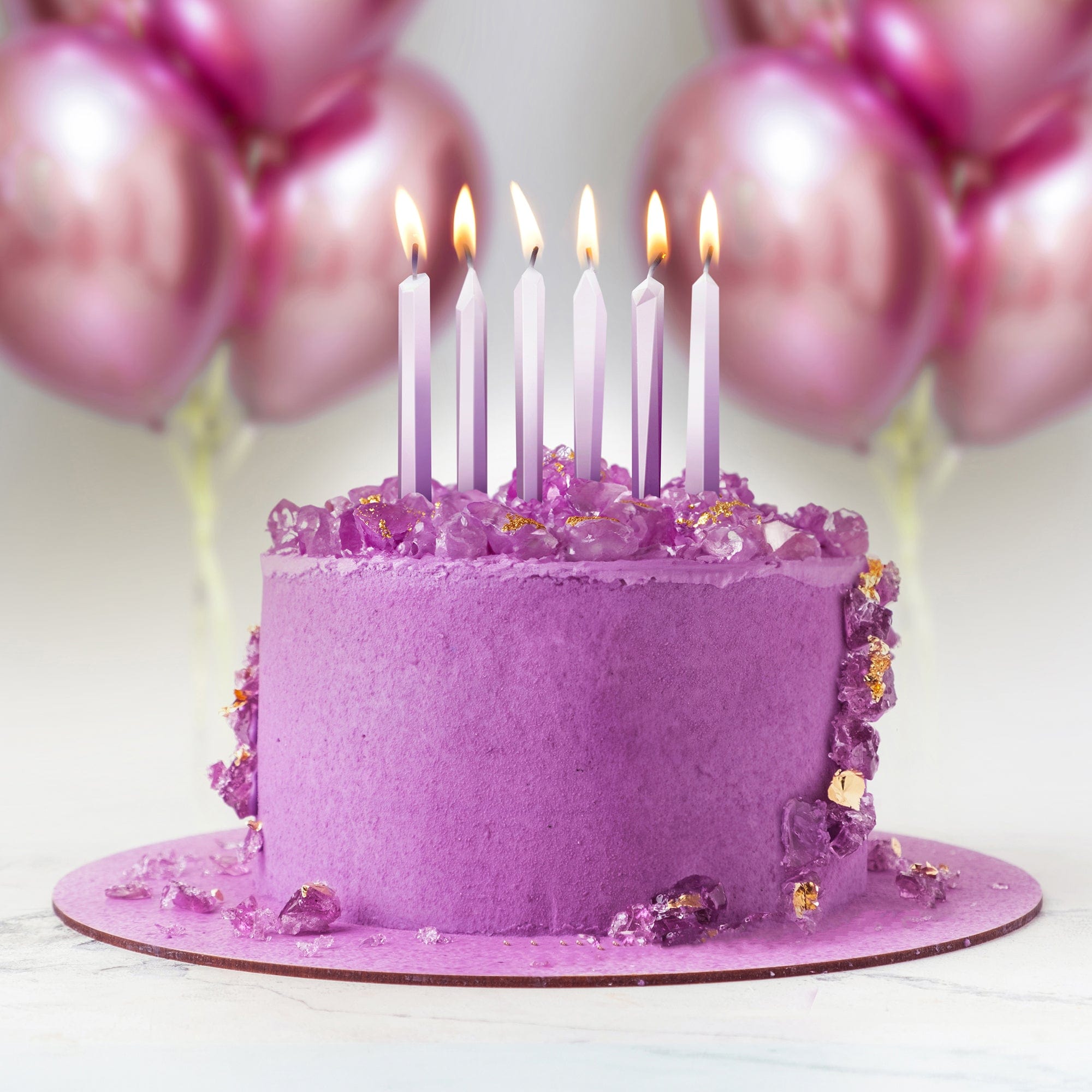 crystal party candles in a purple cake