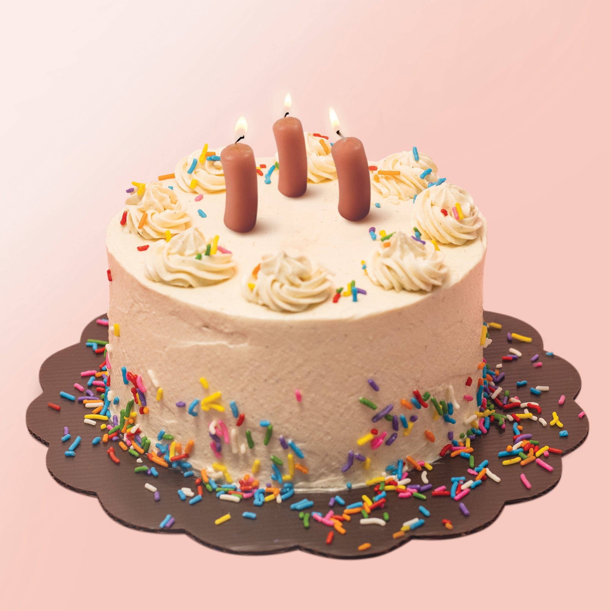 Party candles that look like cocktail wieners on a cake