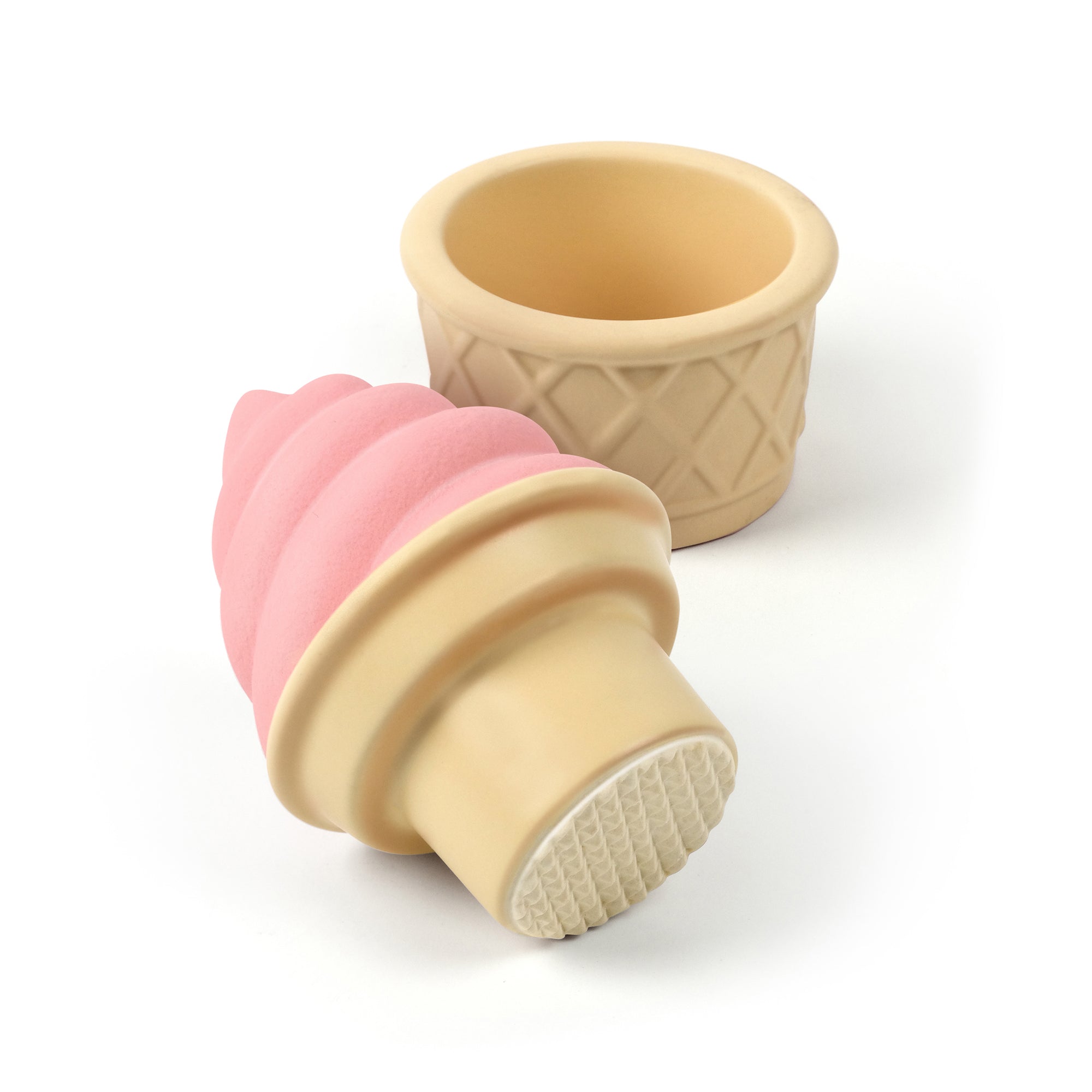 A ceramic spice and herb grinder that looks like strawberry soft serve ice cream in a cone.