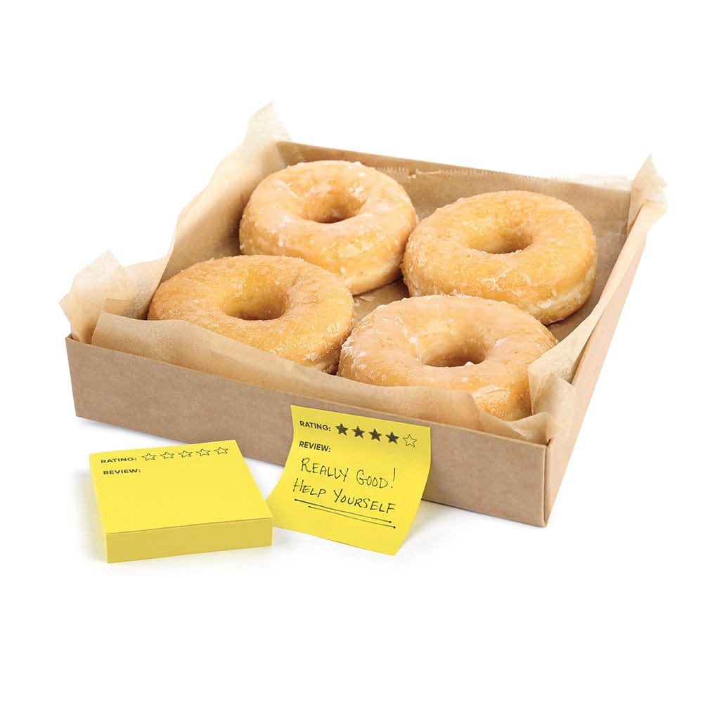 A box of glazed donuts with a yellow stick note that says "Really good! Help Yourself"